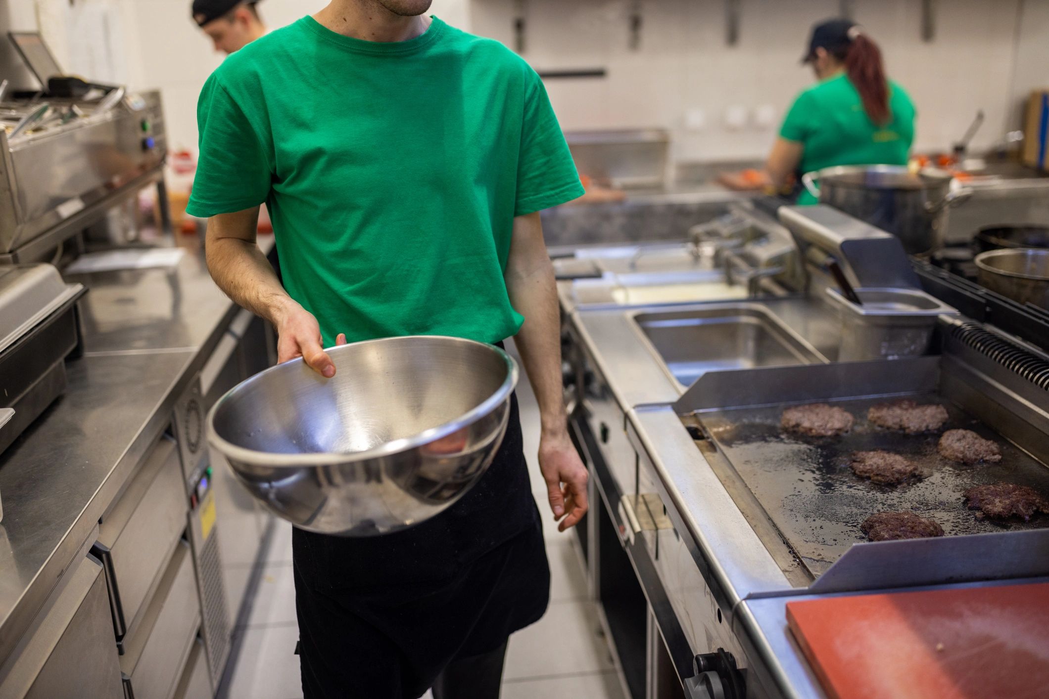 Team members working in a fast food restaurant kitchen