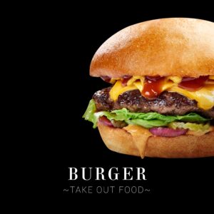 Signature gourmet beef burger on a dark neutral background