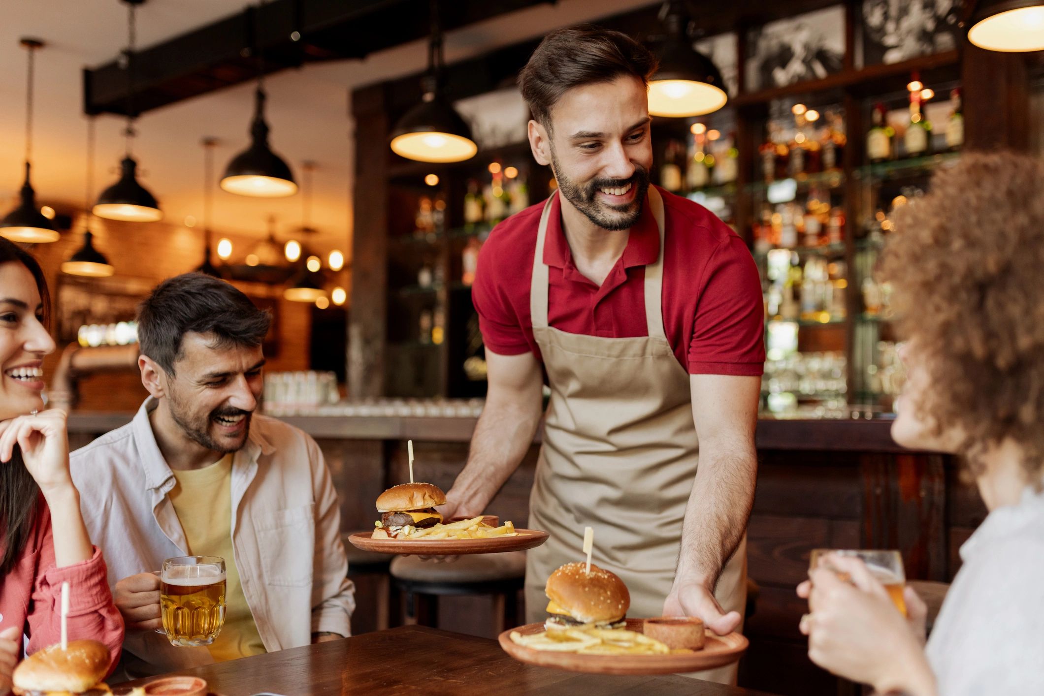 Server delivering burgers to a table